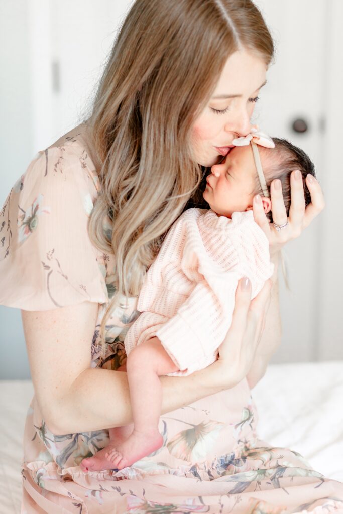 Plymouth Michigan Newborn Photographer captures newborn with momma wearing dress from client closet during photography shoot