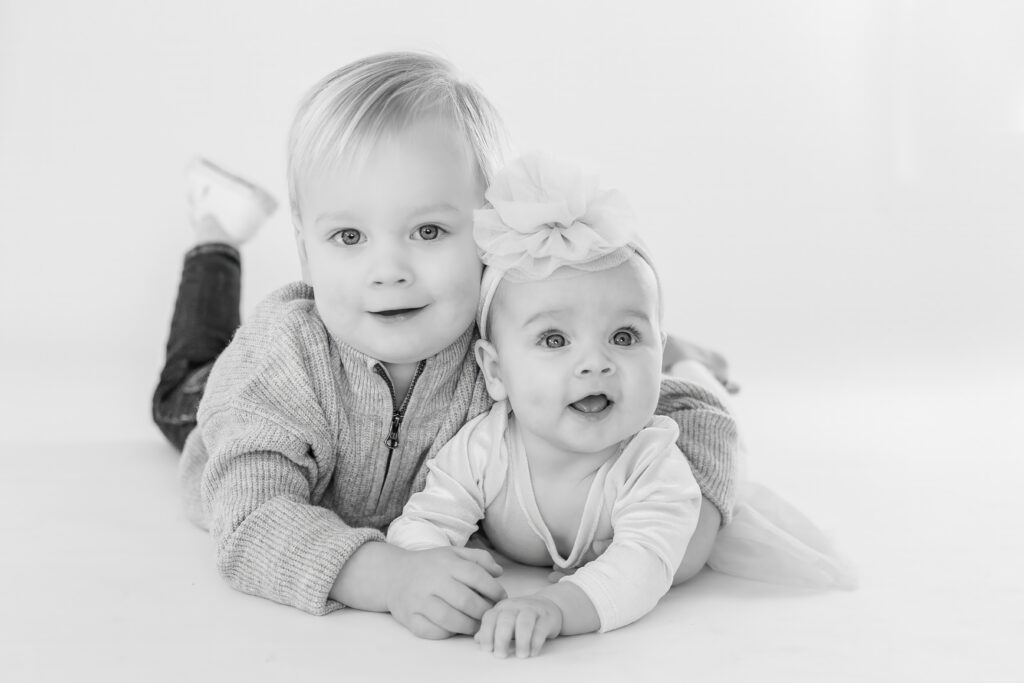 Big Brother and Big Sister pose at Studio Neue for their Personality Mini Session put on by Ann Arbor Newborn Photographer