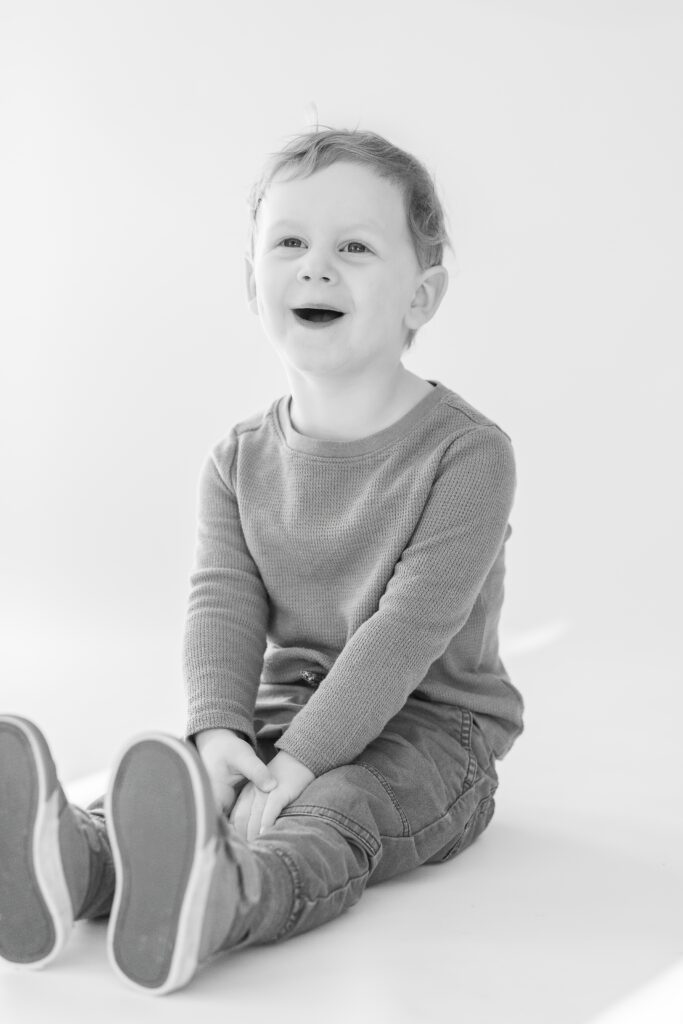 Big Smiles at his Personality Mini Session at Studio Neue in Plymouth Michigan.  Plymouth Michigan Newborn Photographer hosts Milestone Birthday Sessions for families.