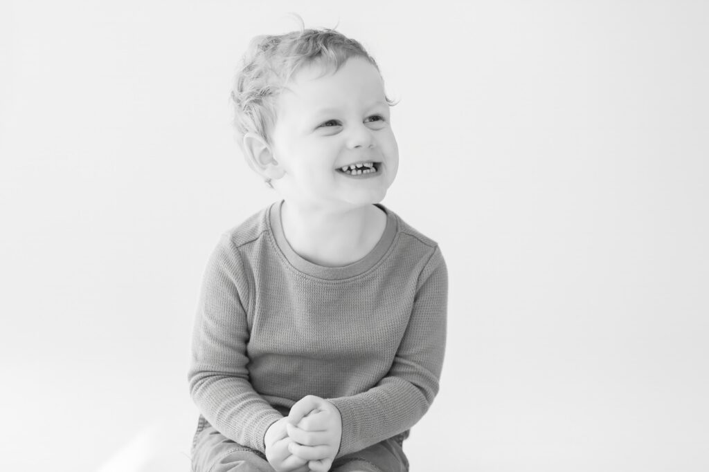 Older brother smiling at personality mini session in Plymouth Michigan put on at Studio Neue by Brooke Leigh Photography