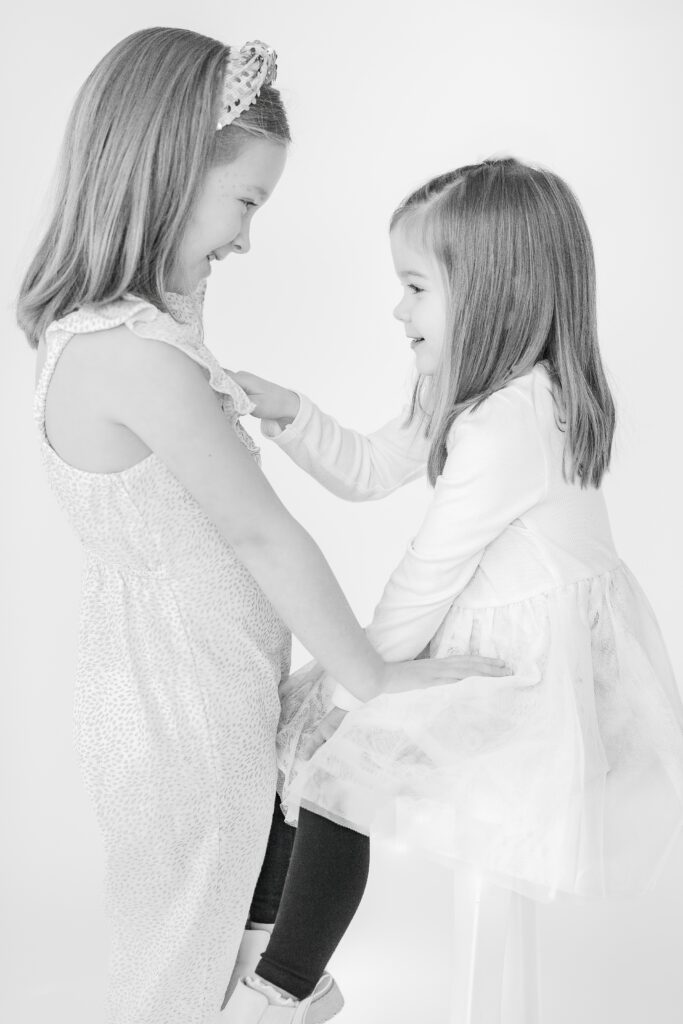 Big and little sisters at their personality mini session at Studio Neue in Plymouth Michigan by Brooke Leigh Photography